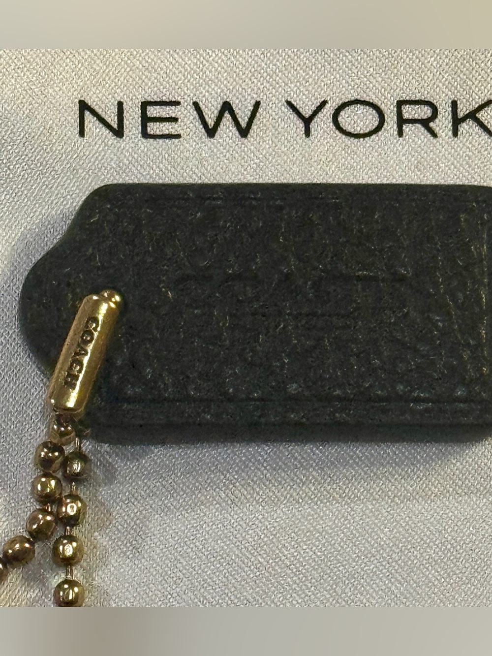 Coach Small Black Pebble Hangtag w/ Gold Chain.